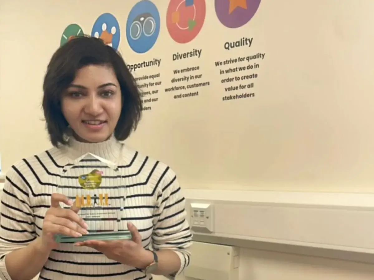 Mishantini Sanderasagran holding the Excellence Award for Autism Enrichment Services (UK)